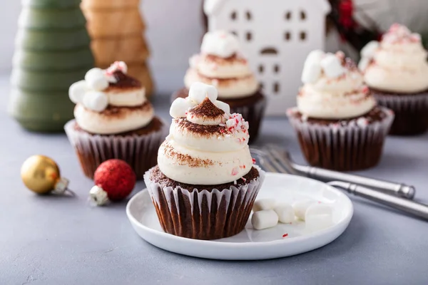 Hot chocolate cupcakes with whipped cream frosting topped with marshmallows and crushed candy cane, Christmas dessert idea