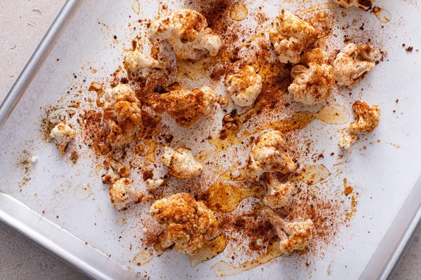 Making roasted cauliflower on a sheet pan with paprika and spices, top view