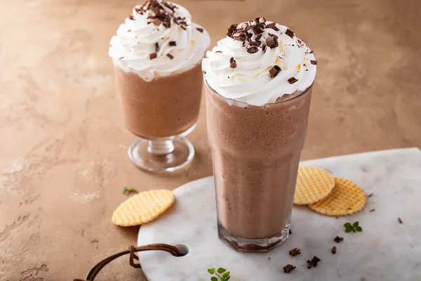 Mocha coffee frappe topped with whipped cream and chocolate curls