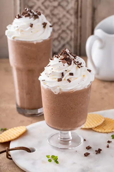 Mocha coffee frappe topped with whipped cream and chocolate curls