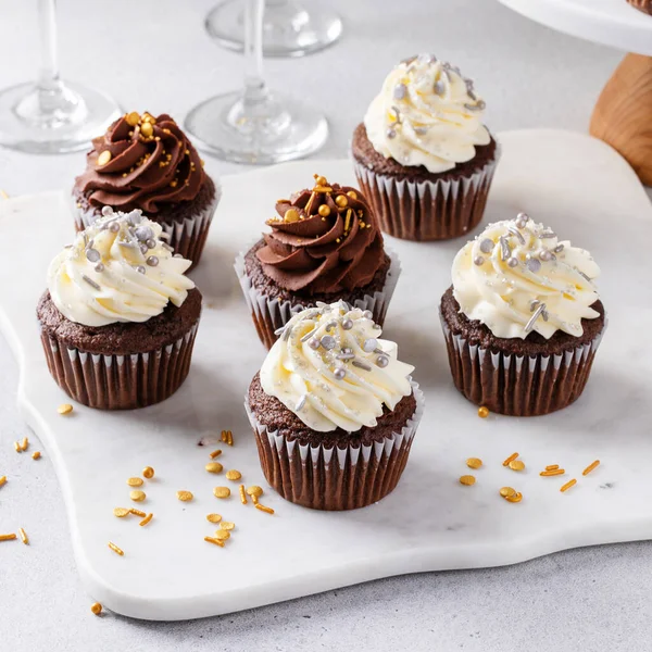 Yeni yıl partisi için şampanyayla servis edilen şekerli kekler, tatlı fikri.