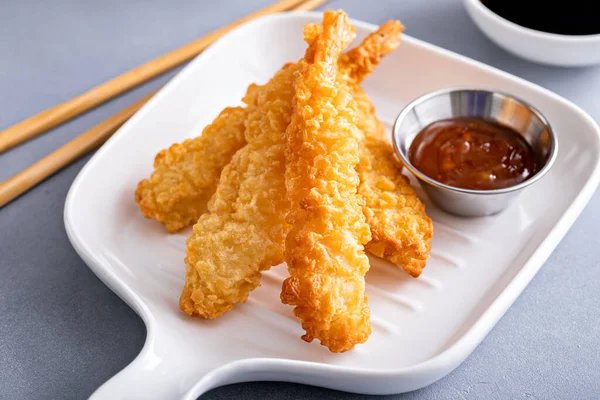 Tempura shrimp single serving on a plate served with sweet and sour sauce and soy sauce, appetizer idea