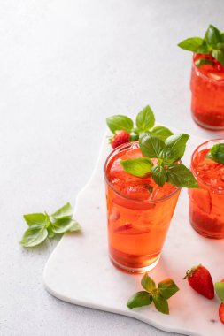 Strawberry basil cocktail or mocktail, cold refreshing summer drink with copy space