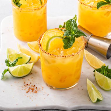 Triple citrus margarita with orange, lemon and lime garnished with mint