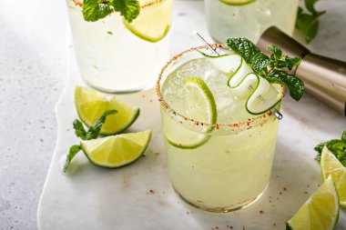 Cucumber margarita with lime and spicy rim, refreshing spring cocktail