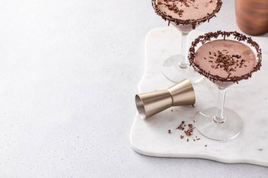 Chocolate martini with chocolate sprinkles on the glass rim with copy space