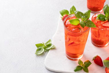 Strawberry basil cocktail or mocktail, cold refreshing summer drink with copy space