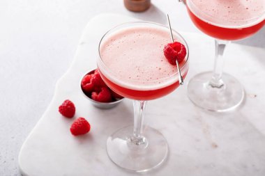 Raspberry martini cocktail with vodka, pineapple juice and raspberry liqueur