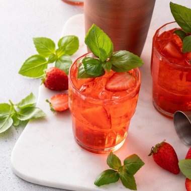 Strawberry basil cocktail or mocktail, cold refreshing summer drink with copy space