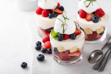 Berry pound cake trifle or parfait with cream cheese mousse and whipped cream, dessert in a glass idea