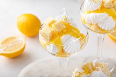 Lemon parfait with pound cake, lemon curd, whipped cream and meringue kisses