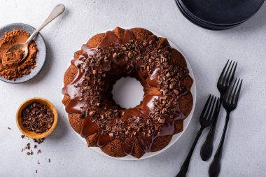 Chocolate bundt cake drizzled with chocolate ganache glaze and chocolate shavings
