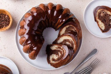 Chocolate marble bundt cake or zebra cake with chocolate glaze sliced overhead view