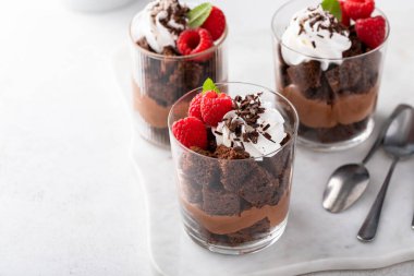 Chocolate trifle or parfait with raspberry, chocolate mousse and whipped cream