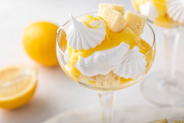 Lemon parfait with pound cake, lemon curd, whipped cream and meringue kisses