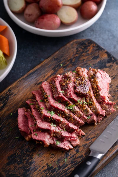 Corned beef cooked and sliced on a cutting board, irish recipe idea for St Patricks day