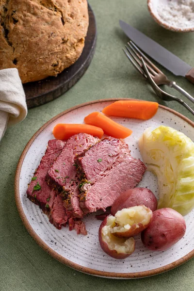 Corned beef with cabbage and potatoes dinner with soda bread, irish recipe idea for St Patricks day