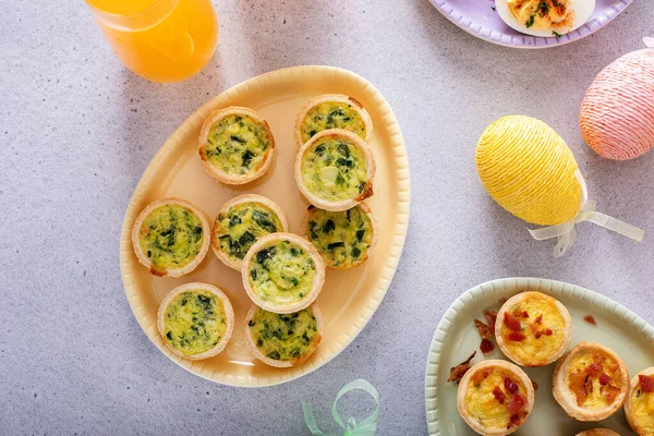 Mini quiches with spinach for Easter brunch, quiche florentine top view