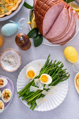 Asparagus cooked on a plate topped with parmesan cheese and soft boiled egg
