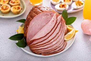 Traditional Easter ham on the table served with Easter brunch clipart