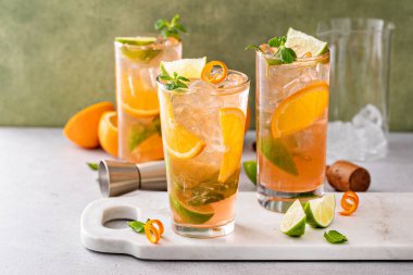 Limonlu ve naneli uzun bardaklarda portakal ve limonlu mojito kokteyli.