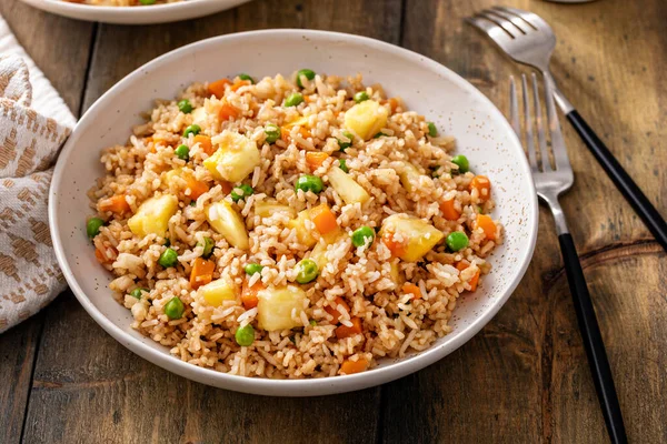 stock image Pineapple fried rice with peas and carrots served in bowls