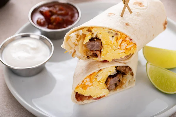 Breakfast burritos with scrambled eggs, sausage, cheese and hash brown potatoes