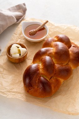 Tereyağı ve bal ile servis edilen taze pişmiş hallah.