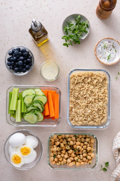 Vegetarian lunch meal prep in containers, high protein meal prep with quinoa, herbed chickpeas, vegetables and boiled eggs
