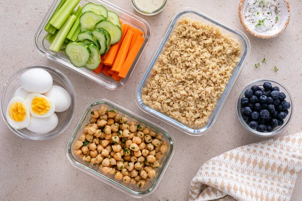 Vegetarian lunch meal prep in containers, high protein meal prep with quinoa, herbed chickpeas, vegetables and boiled eggs