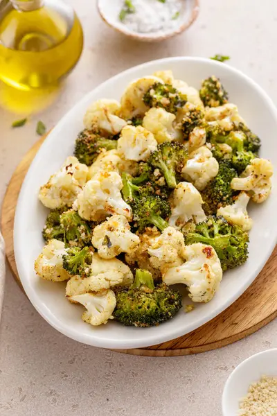 Roasted cauliflower and broccoli on a serving plate, healthy vegetable side dish idea