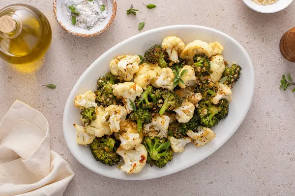 Roasted cauliflower and broccoli on a serving plate, healthy vegetable side dish idea
