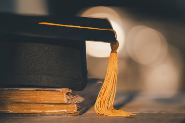 Graduation Cap university pace on wood table graduation concept