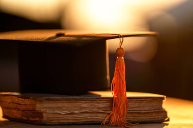 Graduation Cap university pace on wood table graduation concept