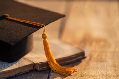 Graduation Cap university pace on wood table graduation concept
