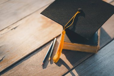Graduation Cap university pace on wood table graduation concept