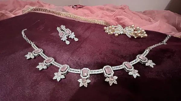 luxury jewelry on white, pink and purple velvet background. Diamon jewelry set for women. Stone diamond jewelry to express love. Perfect for any occasions. Partywear expensive, jewelry. 