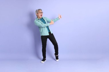 Mor arka planda duran yaşlı Asyalı adamın boyu....