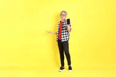 The 40s adult Asian man with casual dressed standing on the yellow background.