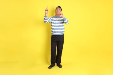 The 40s adult Asian man with standing on the yellow background.