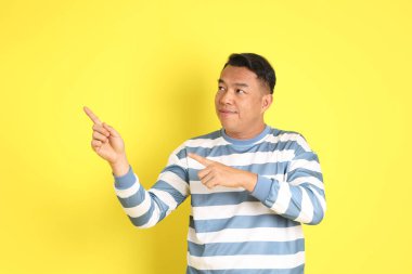 The 40s adult Asian man with standing on the yellow background.