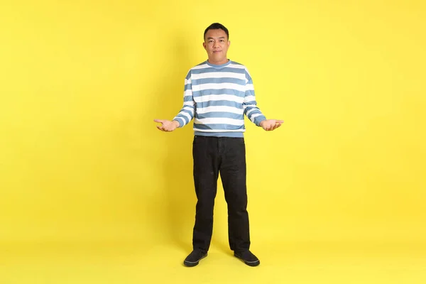 Sarı Arka Planda Duran Yaşlardaki Asyalı Adam — Stok fotoğraf