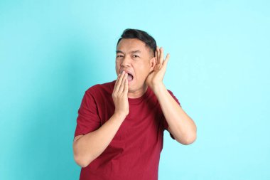 The 40s adult Asian man with standing on the green background.