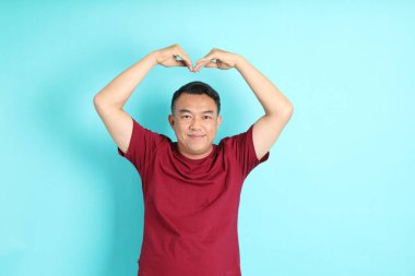 The 40s adult Asian man with standing on the green background.