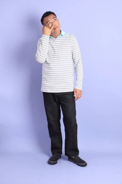 The 40s adult Asian man with standing on the purple background.