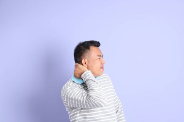 The 40s adult Asian man with standing on the purple background.