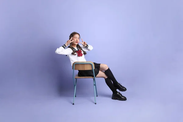 Asijky Dívka Japonské Studentské Uniformě Stojící Fialovém Pozadí — Stock fotografie