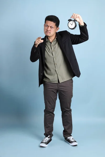 The adult business Asian man in smart casual clothes standing on the green background background.