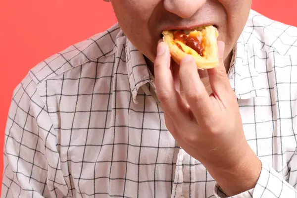 Hombre Asiático Comiendo Tarta Huevo Fondo Naranja — Foto de Stock