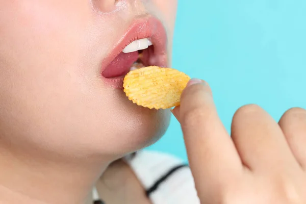 Azjatka Jedząca Chipsy Ręki Żółtym Tle — Zdjęcie stockowe